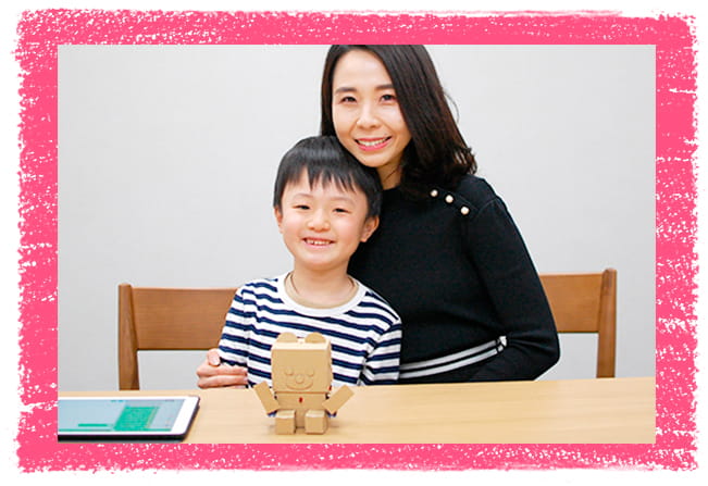 創意工夫をし完成したembotと一緒に微笑む親子の写真